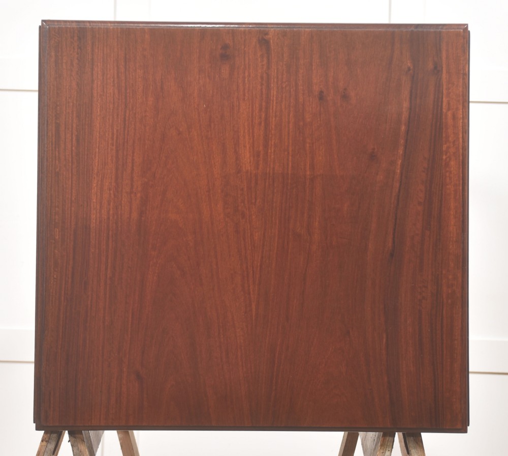 A pair of rosewood drop-leaf side tables featuring single drawers above cupboard doors with brass grille inserts, standing on square tapered legs with brass castors. View VIII