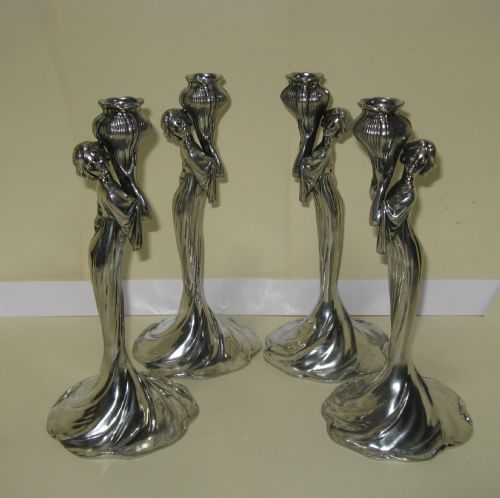 Set of Four Art Nouveau Polished Pewter Candle Holders 
