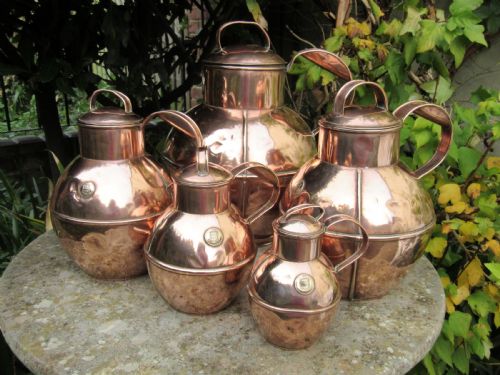 Five Graduated Martin's Guernsey Copper Milk Jugs