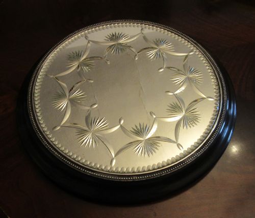 fig 2. A circular Victorian mirrored table plateau featuring wheel-cut starburst patterns framed by a beaded metal rim on a turned ebonised wood base.