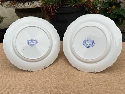 fig 2. A group of six early 19th-century Staffordshire blue and white transferware ceramic plates displaying pastoral, coastal, and floral patterns with scalloped borders.