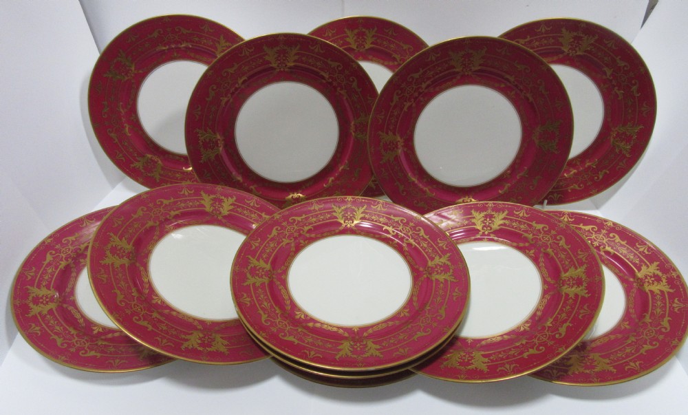 SET OF TWELVE LIMOGES RAISED GILT DINNER PLATES