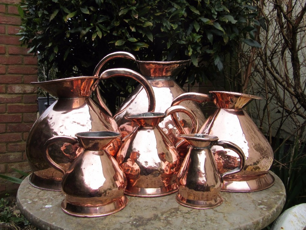SIX GRADUATED ANTIQUE COPPER MEASURES