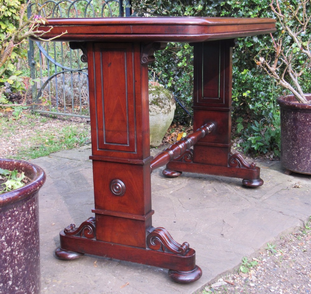 A William IV mahogany metamorphic serving table featuring a smooth rectangular top supported by panelled pedestal ends and a turned central stretcher. View III