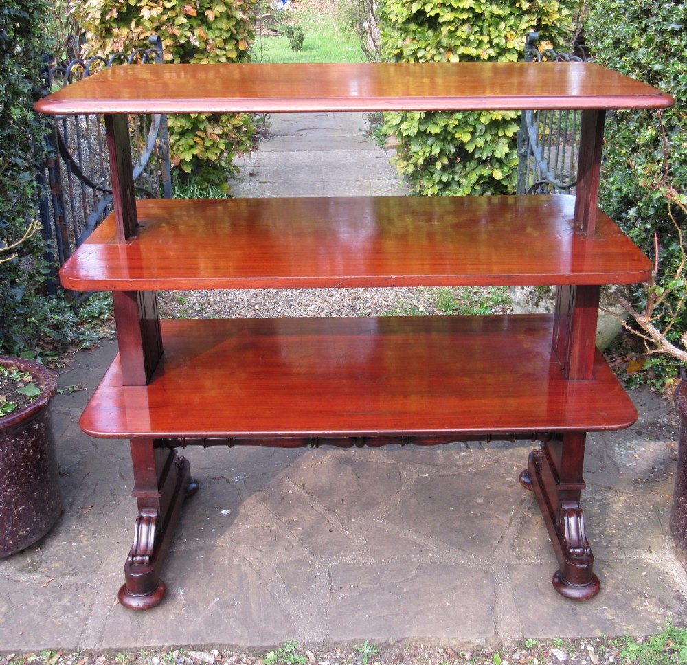 A William IV mahogany metamorphic serving table featuring a smooth rectangular top supported by panelled pedestal ends and a turned central stretcher. View V
