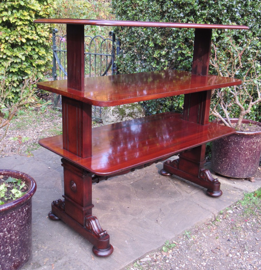 A William IV mahogany metamorphic serving table featuring a smooth rectangular top supported by panelled pedestal ends and a turned central stretcher. View VI