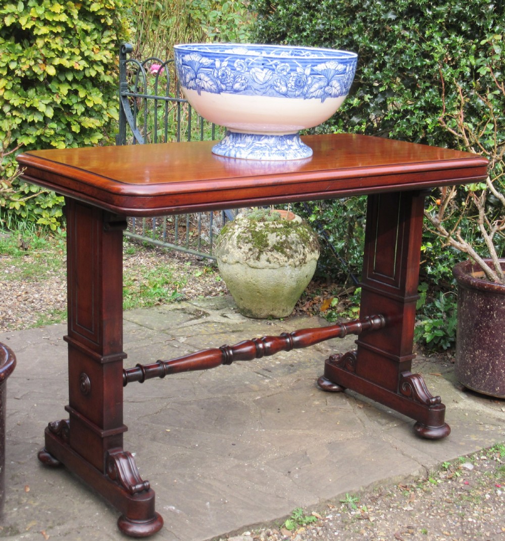 A William IV mahogany metamorphic serving table featuring a smooth rectangular top supported by panelled pedestal ends and a turned central stretcher. View VII
