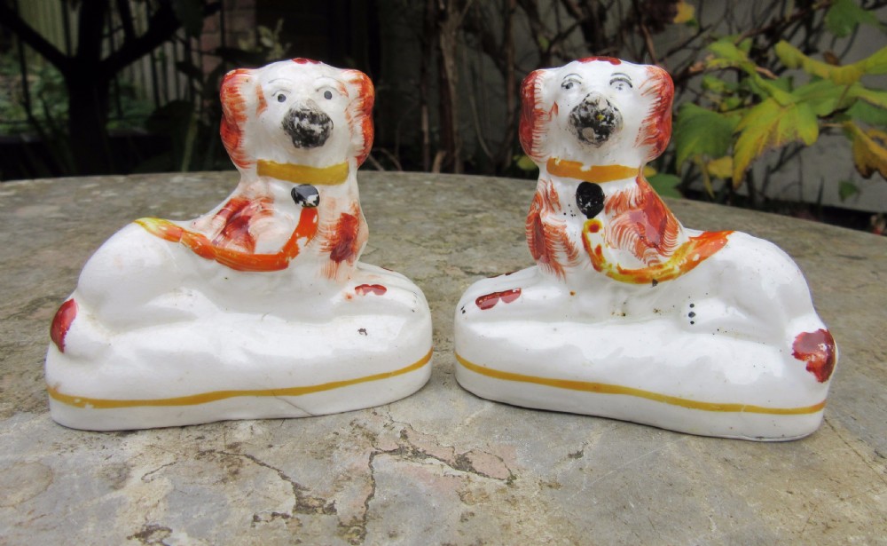 PAIR OF SMALL VICTORIAN RECUMBENT STAFFORDSHIRE DOGS c1860