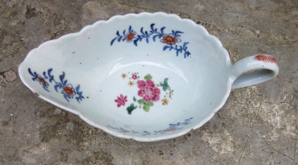 An 18th-century Chinese export porcelain sauceboat decorated in the Tobacco Leaf pattern with a loop handle and scalloped rim. View II