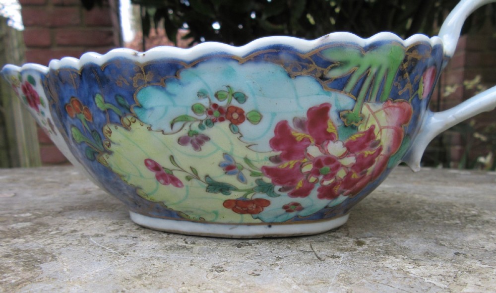 An 18th-century Chinese export porcelain sauceboat decorated in the Tobacco Leaf pattern with a loop handle and scalloped rim. View V