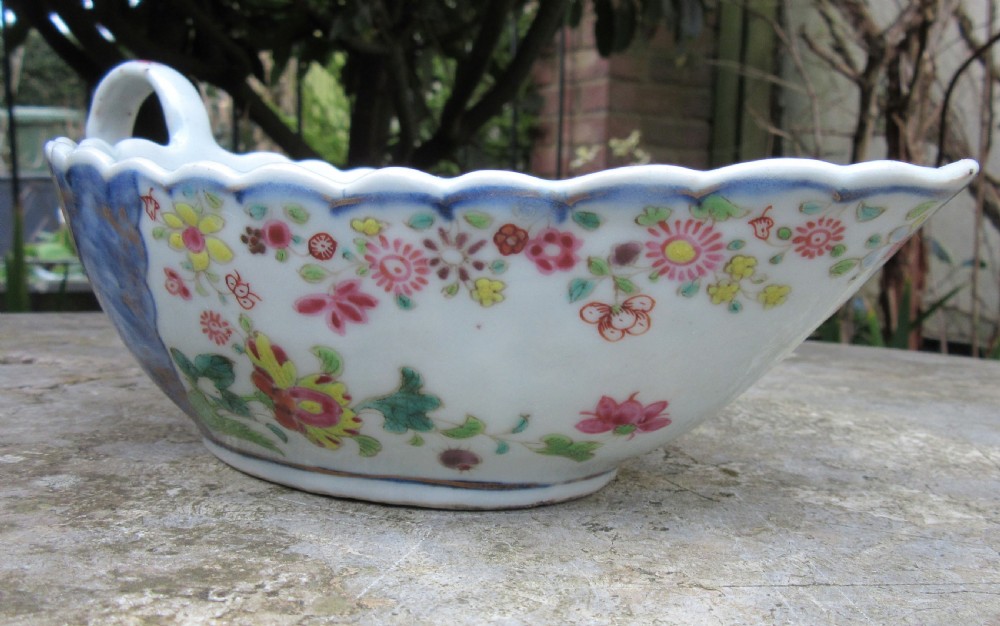 An 18th-century Chinese export porcelain sauceboat decorated in the Tobacco Leaf pattern with a loop handle and scalloped rim. View VI