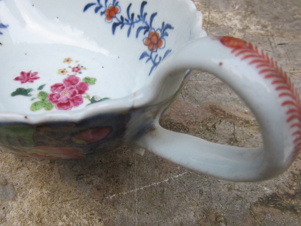 An 18th-century Chinese export porcelain sauceboat decorated in the Tobacco Leaf pattern with a loop handle and scalloped rim. View IX