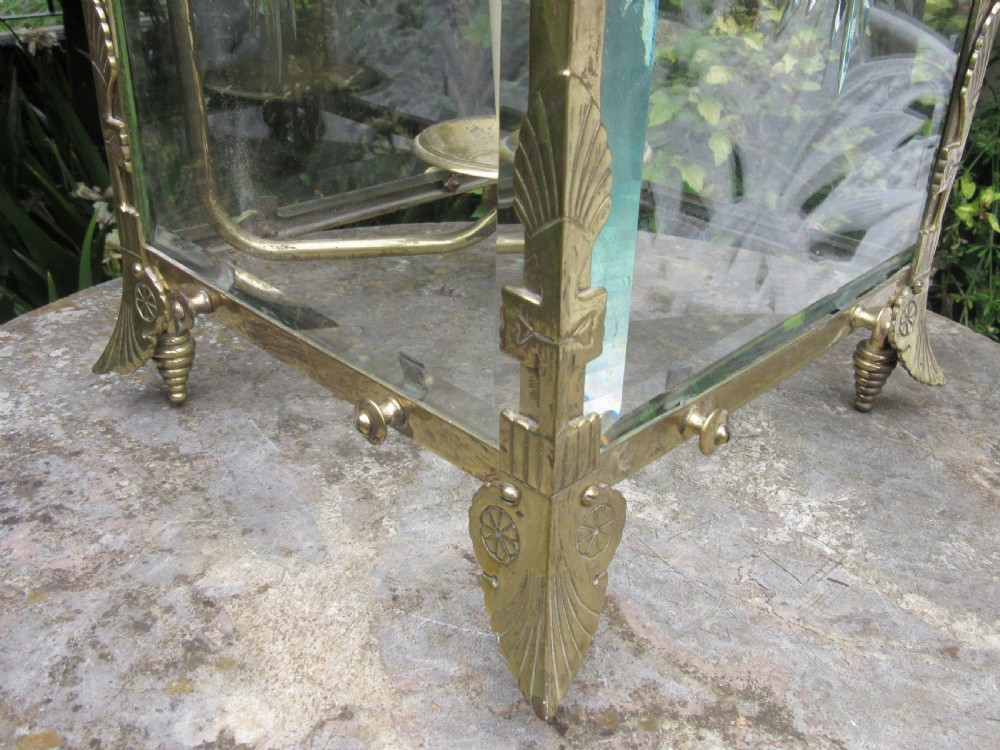 An English late 19th-century brass hall lantern with bevelled glass panels featuring starburst engravings and an arched top structure. View IV