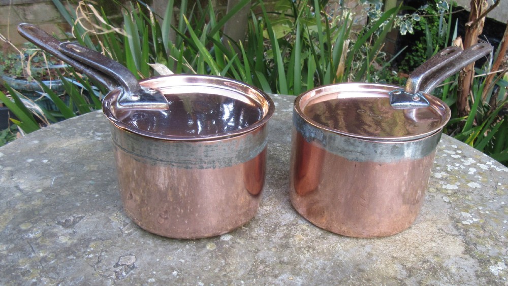 TWO FINE STAMPED COPPER PANS & LIDS c1880