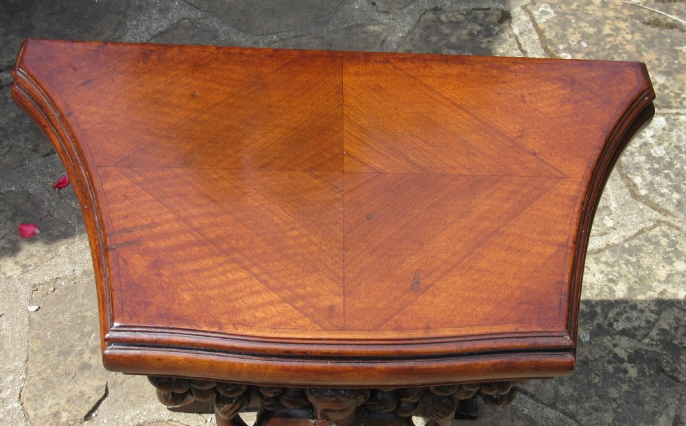 An antique Italian carved walnut pier table featuring a shaped top above a central carved caryatid figure resting on a scrolled base. View III