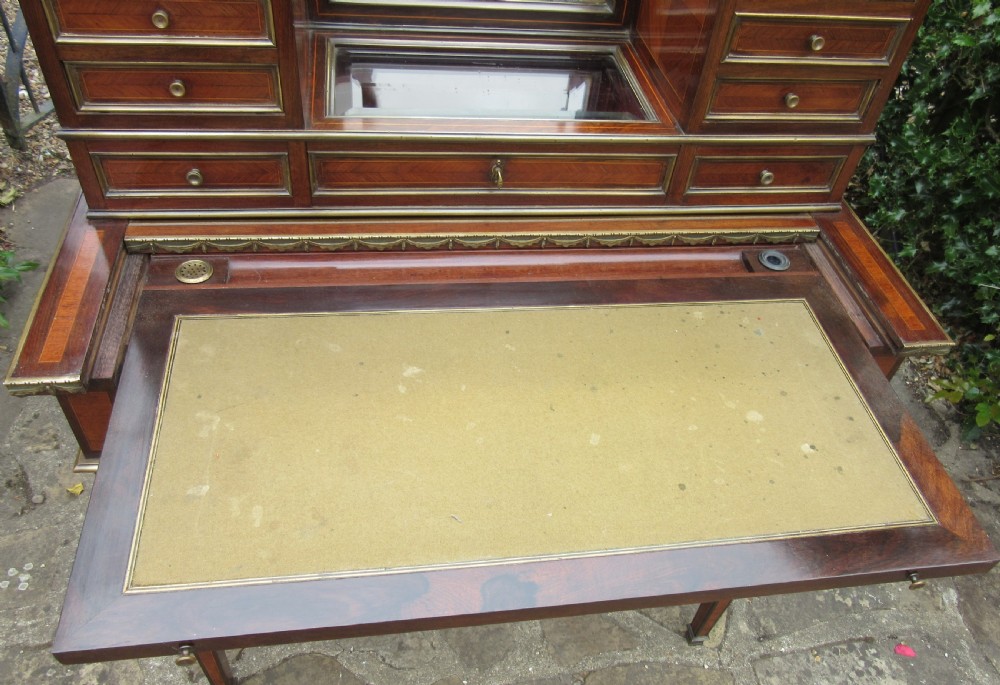 A late 19th-century rosewood bonheur du jour writing desk featuring brass gallery railings, an arched central mirror, multiple small drawers, and tapered legs. View VII