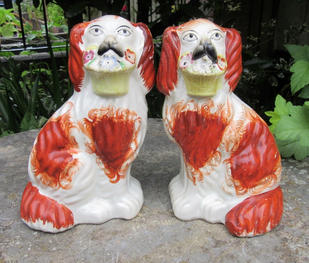 PAIR OF VICTORIAN STAFFORDSHIRE DOGS WITH BASKETS c1860