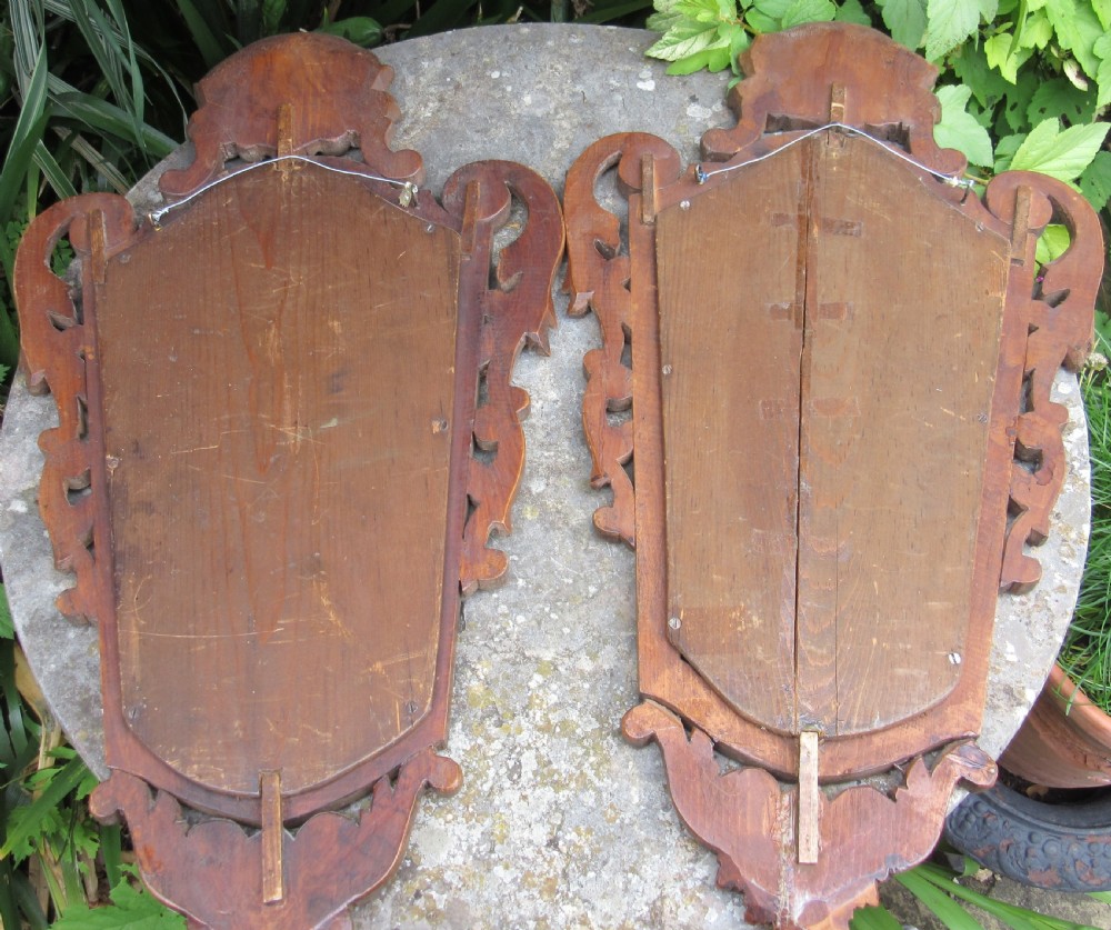 A pair of early 20th-century carved pine wall mirrors featuring shell crests and intricate scrollwork frames. View III
