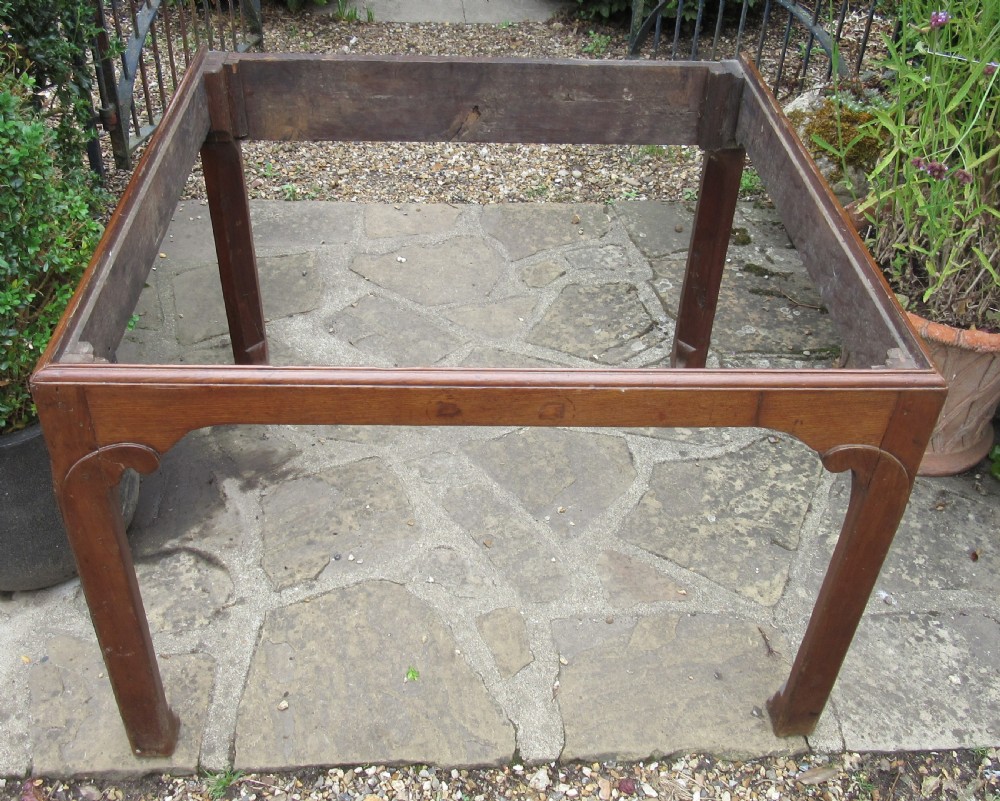 A Georgian mahogany estate desk featuring a slanted writing surface with a dark inset leather skiver, raised scrolled gallery back, and square legs with decorative corner spandrels. View IX
