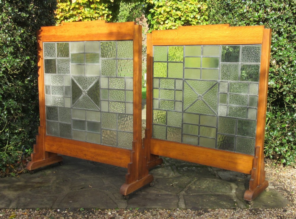 A pair of Art Deco medium oak screens featuring geometric leaded textured glass panels and stepped feet. View III