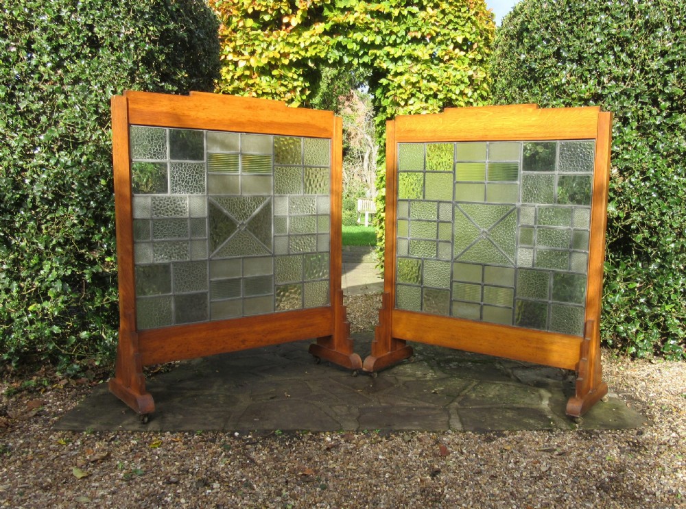 A pair of Art Deco medium oak screens featuring geometric leaded textured glass panels and stepped feet. View V