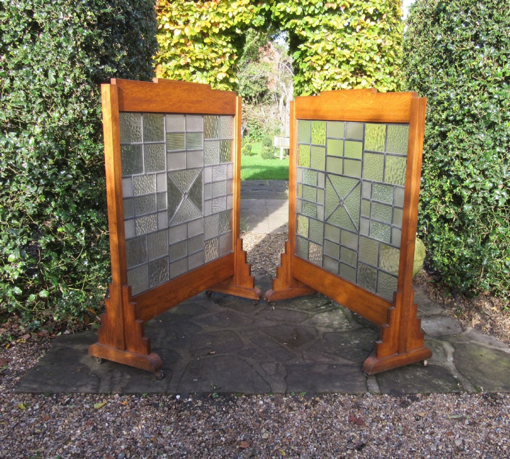 A pair of Art Deco medium oak screens featuring geometric leaded textured glass panels and stepped feet. View VI