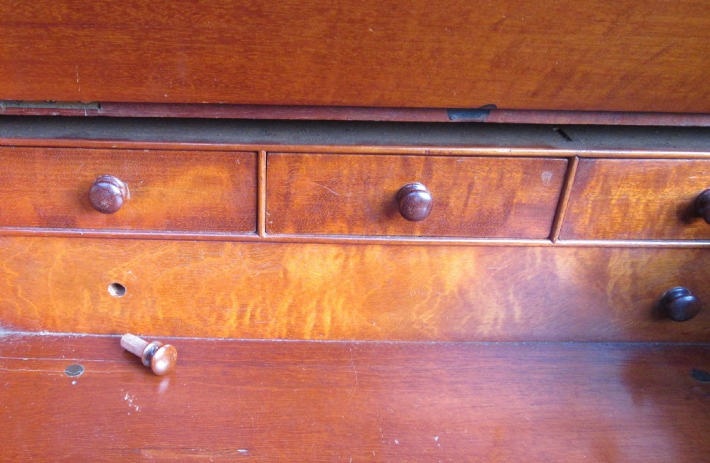 An antique Victorian figured walnut writing slope featuring a brass gallery rail and a brown leather writing surface with decorative gold tooling. View IV