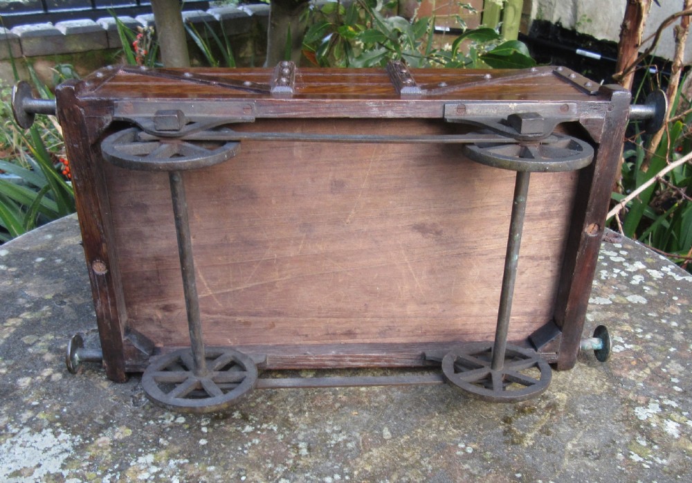 A late Victorian oak humidor designed in the form of a miniature railway coal wagon with metal wheels, buffers, and brass studs. View VII