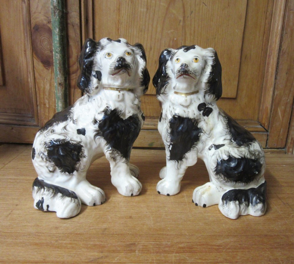 PAIR OF BLACK & WHITE PORCELLANEOUS STAFFORDSHIRE DOGS c1840