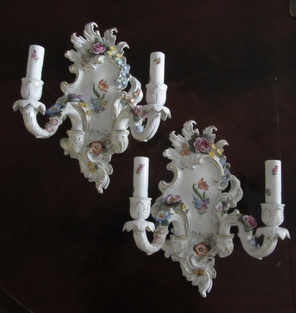A pair of German Rococo Revival porcelain two-arm wall sconces featuring encrusted polychrome flowers, gilded scrollwork, and hand-painted floral motifs. View V