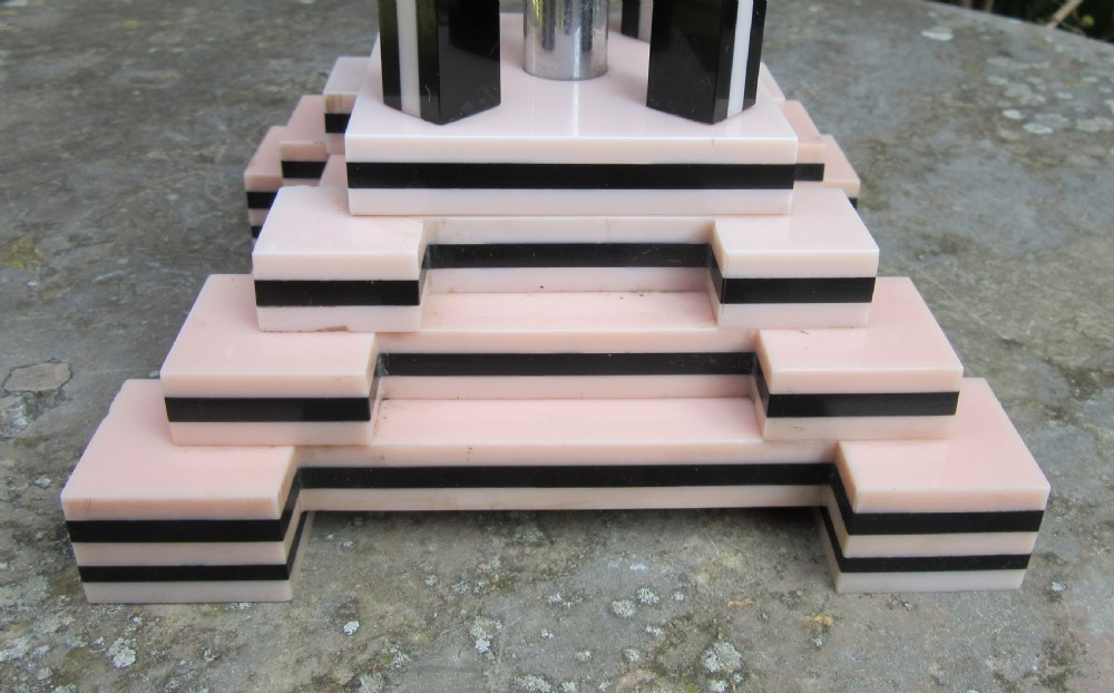 An Art Deco table lamp base featuring a stepped ziggurat foundation and vertical black and pink layered columns. View II