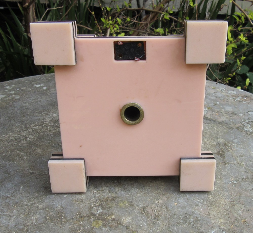 An Art Deco table lamp base featuring a stepped ziggurat foundation and vertical black and pink layered columns. View VI