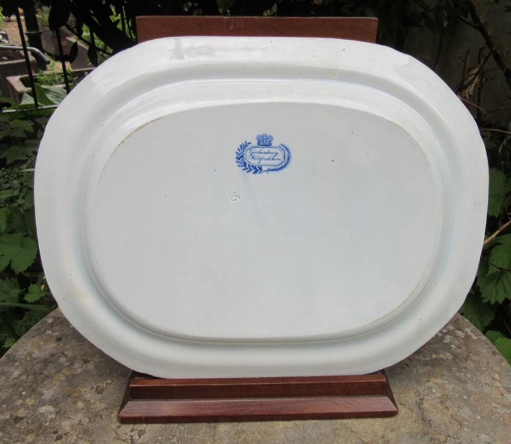 A rectangular blue and white transferware earthenware platter with rounded corners depicting a stately country estate encircled by an oak leaf border. View III