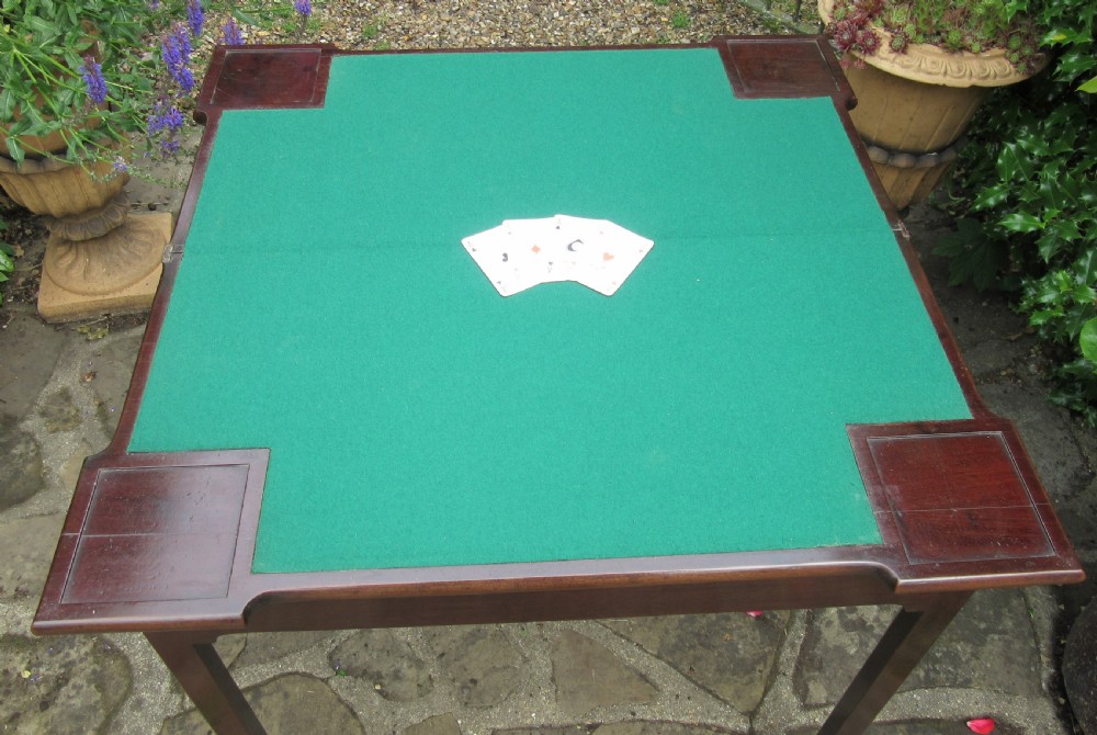 A Georgian mahogany fold-over card table with shaped outset corners and four square straight legs. View VI