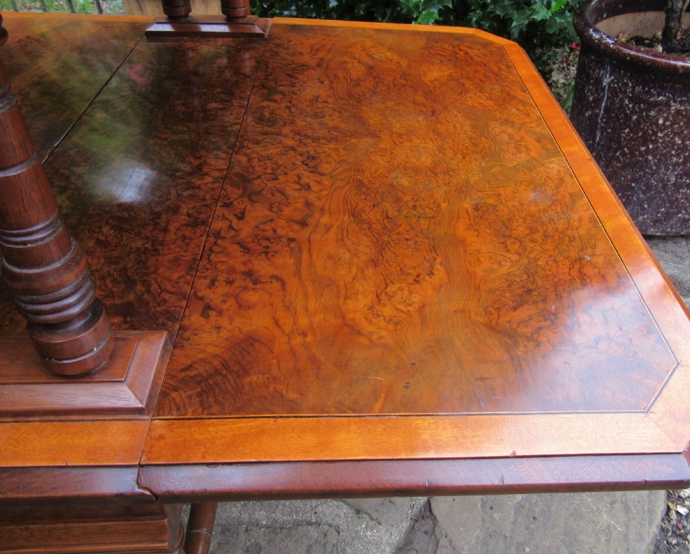 A two-tier Victorian burr walnut Sutherland tea table with folded drop leaves and turned spindle supports. View IV