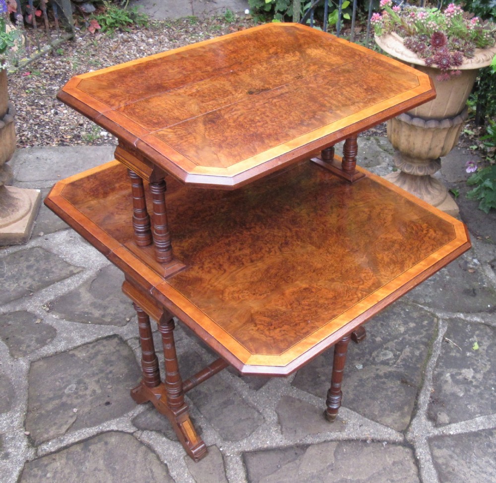 A two-tier Victorian burr walnut Sutherland tea table with folded drop leaves and turned spindle supports. View VI