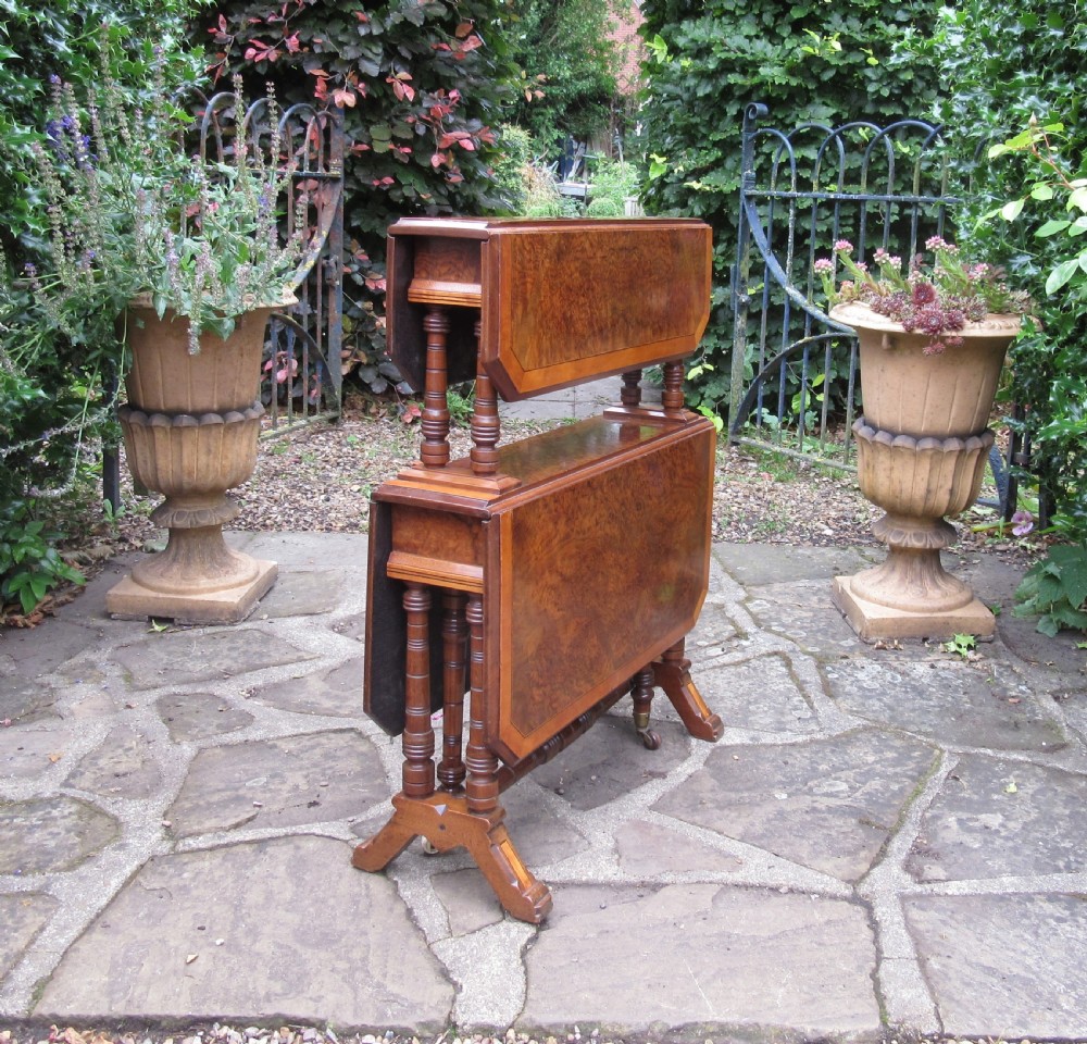 A two-tier Victorian burr walnut Sutherland tea table with folded drop leaves and turned spindle supports. View XII