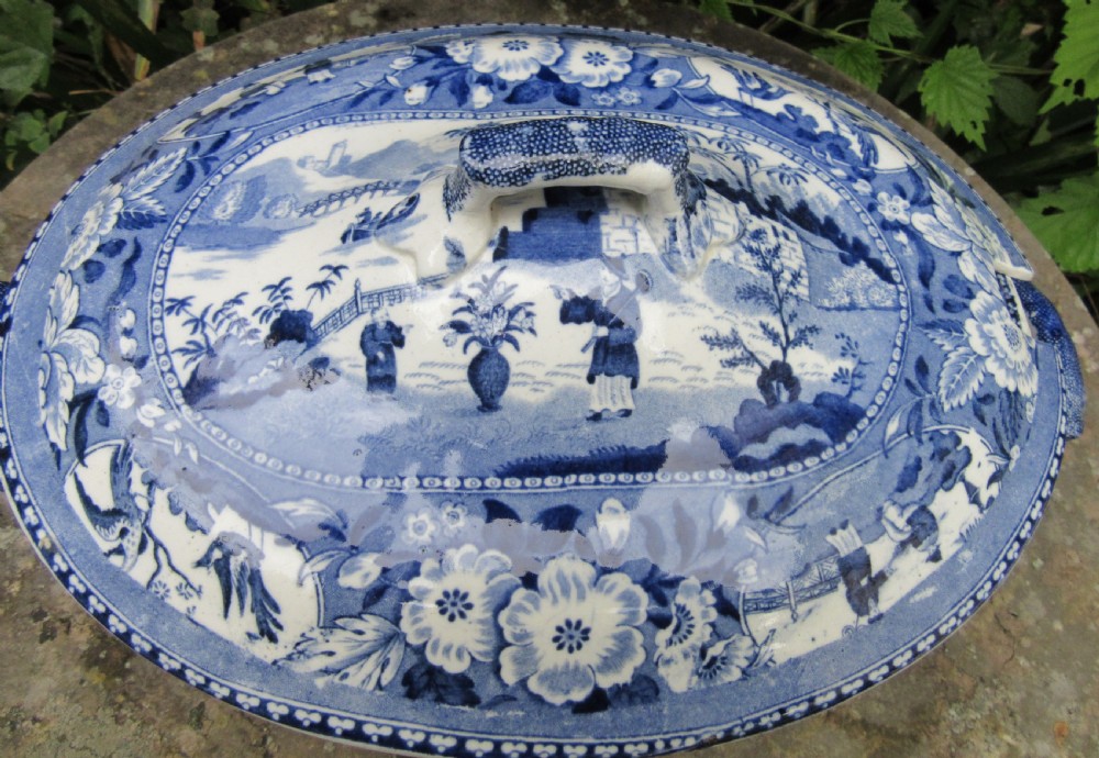 An antique 1830 Staffordshire earthenware tureen featuring blue and white Chinoiserie transferware decoration with a matching lid and side handles. View II