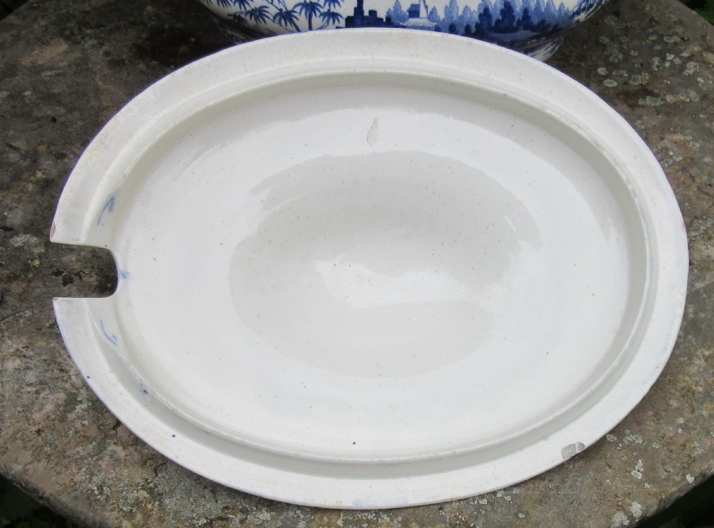 An antique 1830 Staffordshire earthenware tureen featuring blue and white Chinoiserie transferware decoration with a matching lid and side handles. View III