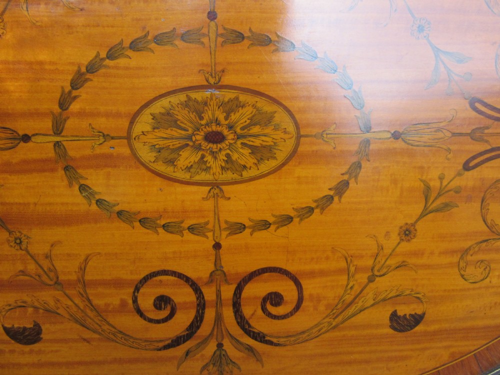 An oval satinwood serving tray featuring detailed central floral marquetry inlay, a pierced brass gallery rim, and two brass handles. View II