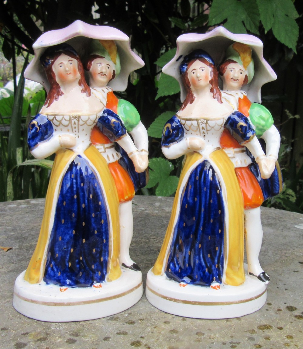 TWO MATCHING STAFFORDSHIRE DANCING UMBRELLA FIGURES c1860