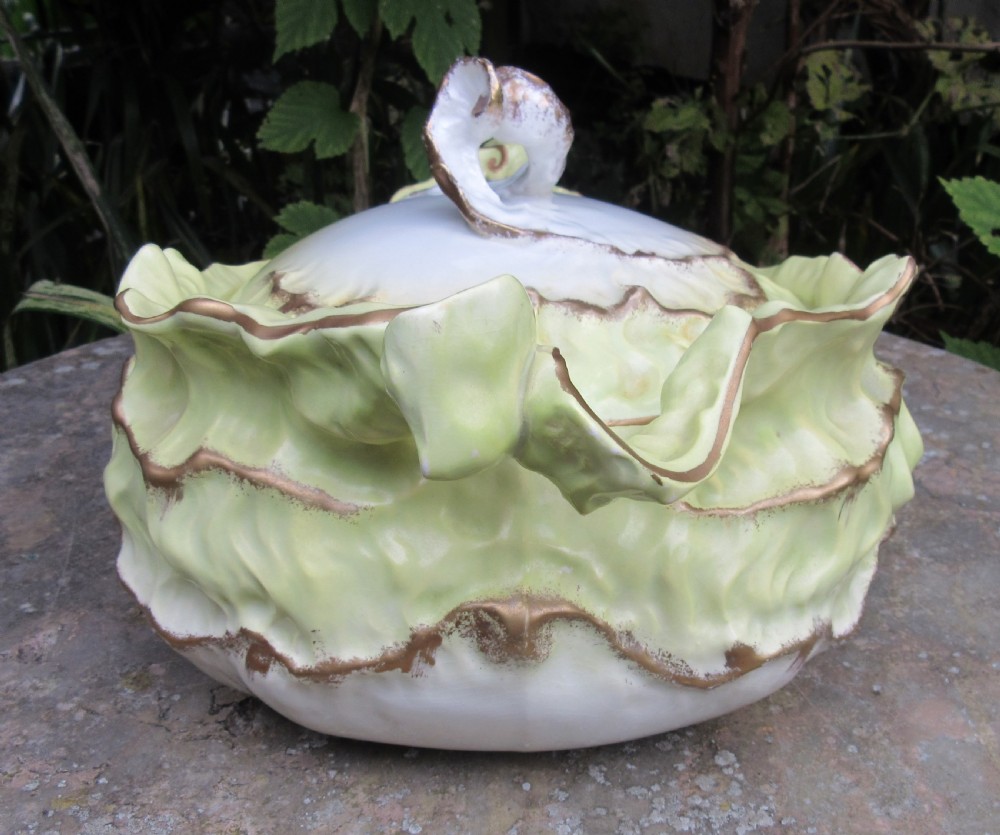 A Victorian Staffordshire ceramic soup tureen with lid, moulded in the shape of cabbage leaves with a pale green wash and gilded leaf rims. View IV