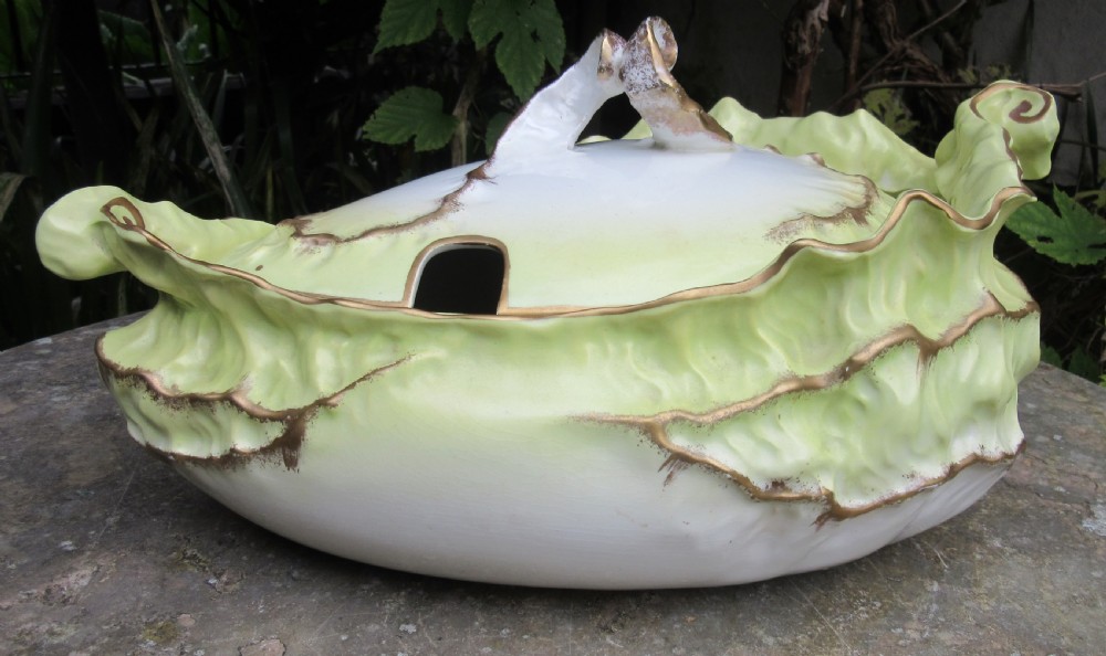 A Victorian Staffordshire ceramic soup tureen with lid, moulded in the shape of cabbage leaves with a pale green wash and gilded leaf rims. View VII