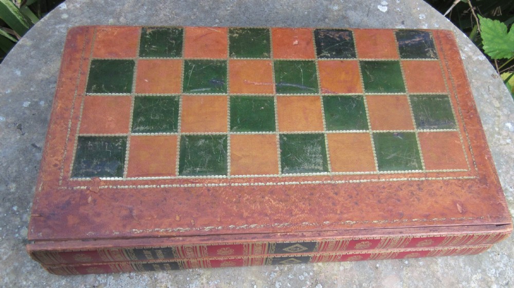 A Victorian folding leather games board designed to resemble two red volumes titled History of Russia with a green and brown chequered surface on top. View II