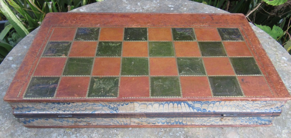 A Victorian folding leather games board designed to resemble two red volumes titled History of Russia with a green and brown chequered surface on top. View V