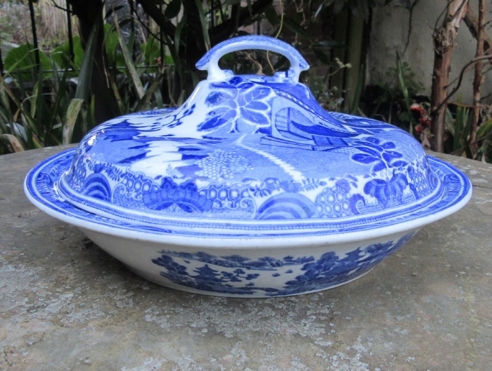 An antique early Victorian Copeland and Garrett blue and white transferware ceramic tureen with a domed lid and landscape pattern.