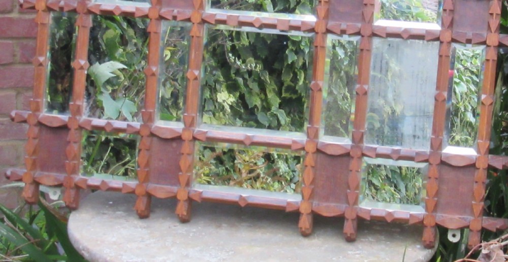 A Victorian Oxford Movement carved oak wall mirror featuring three gabled crests, a cross-hatched lattice structure, and multiple bevelled mirror plates. View II