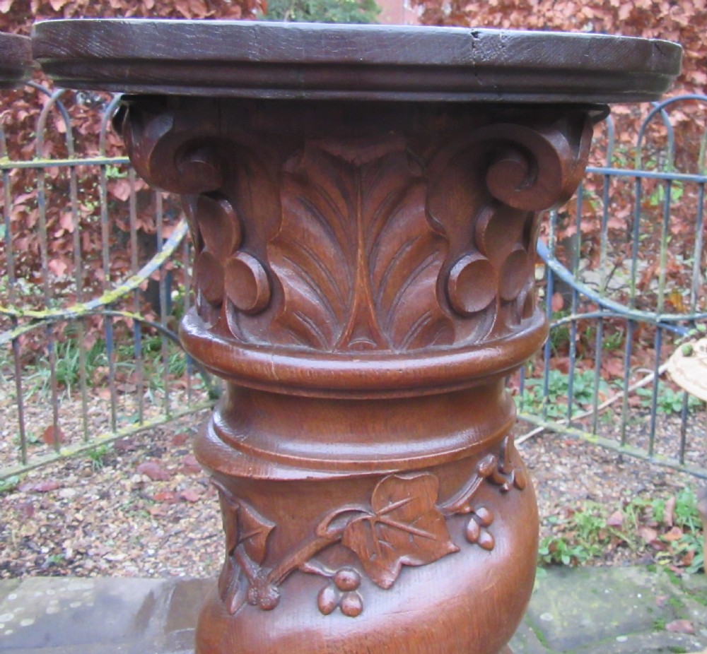 A pair of carved oak spiral column pedestals featuring acanthus leaf capitals, foliage relief carving, and square stepped plinth bases. View II