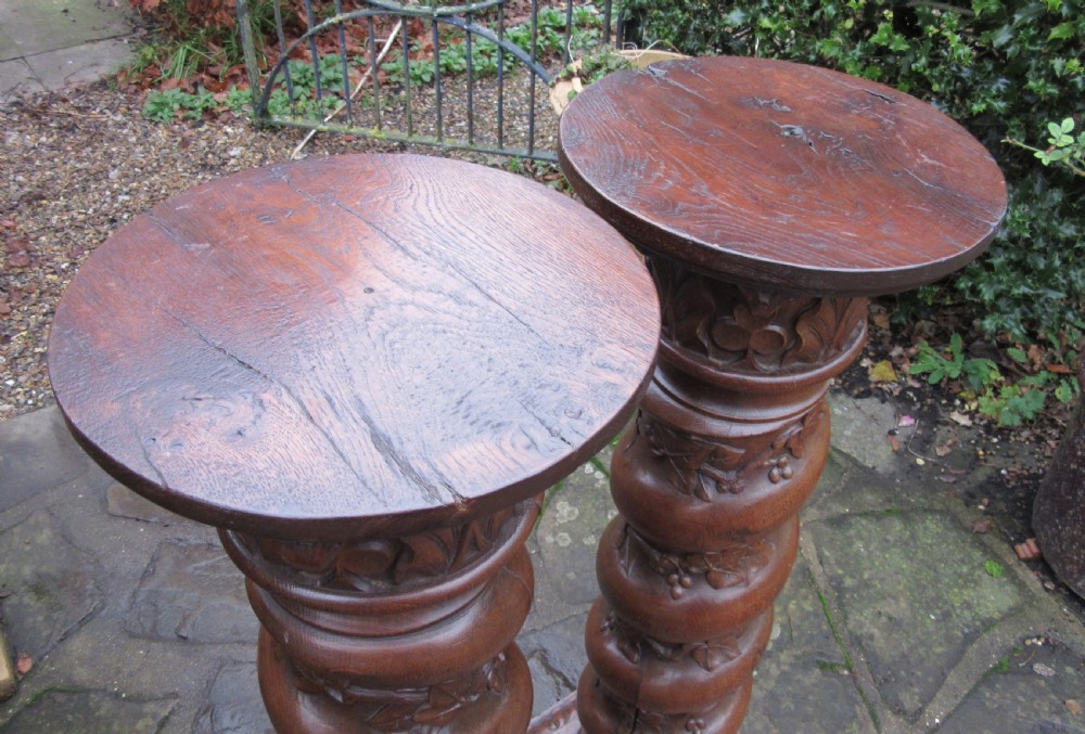 A pair of carved oak spiral column pedestals featuring acanthus leaf capitals, foliage relief carving, and square stepped plinth bases. View VII