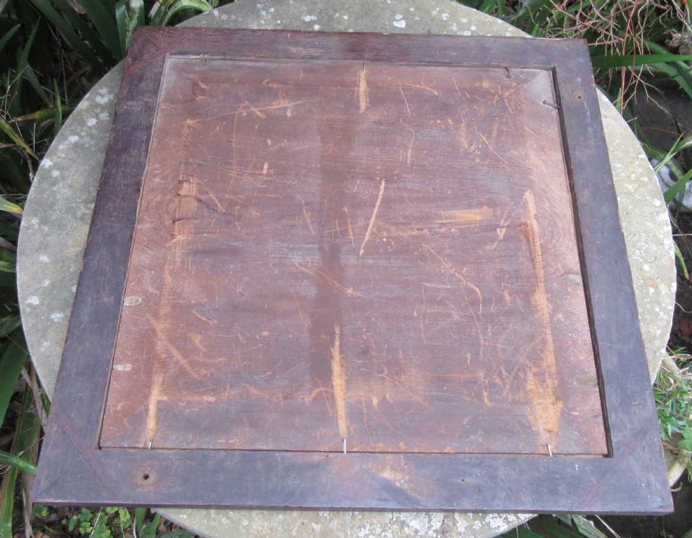A square Victorian reverse-painted glass chess board with light blue and marbled squares, surrounded by a gilt scrollwork border and framed in dark moulded wood. View IV